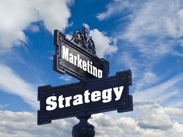 An image of a sign with the top saying "marketing" and the bottom saying "strategy" to discuss why I chose to help businesses with marketing strategy vs content development.